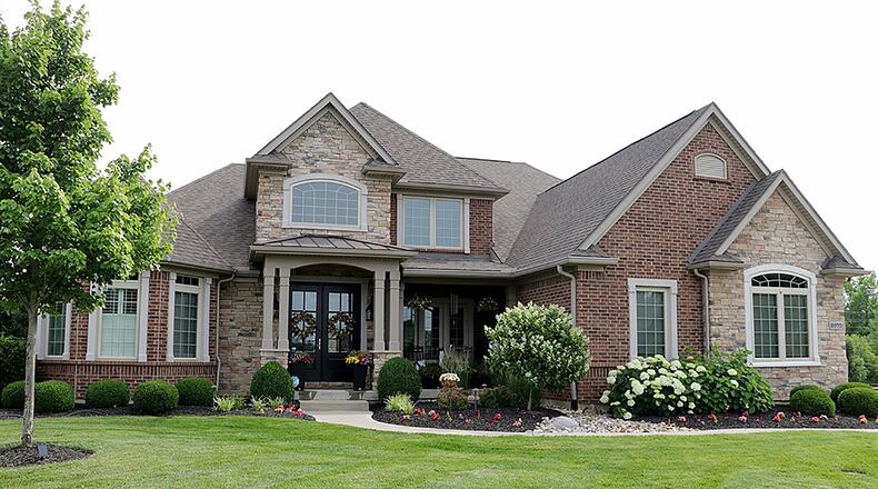 The 2-story home with 5 bedrooms has about 5,780 sq. ft. of living space. The property is at the end of a cul-de-sac with a tree-lined back yard surrounded by a fence. An extra parking pad is near the side-entry, 3-car garage. CONTRIBUTED PHOTO BY KATHY TYLER