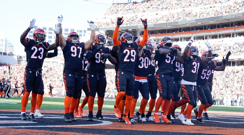 The Cincinnati Bengals defense celebrates an interception against the Carolina Panthers during the first half of an NFL football game, Sunday, Nov. 6, 2022, in Cincinnati. (AP Photo/Jeff Dean)