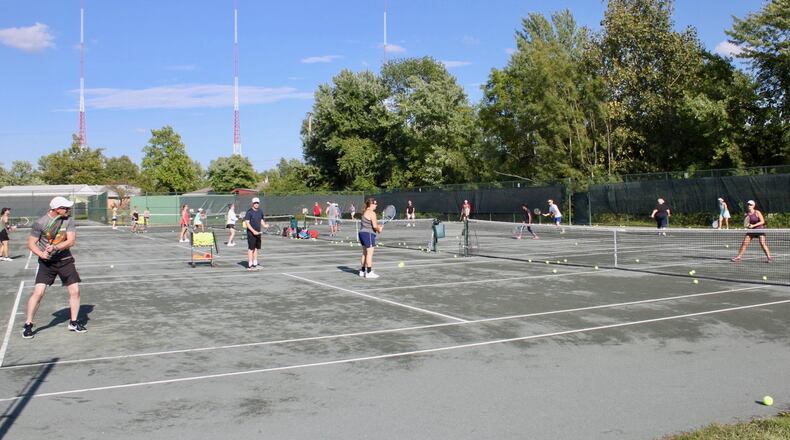 Players from Kettering Tennis Center and Quail Run Racquet Club take part in a recent Live Ball clinic in Kettering. “You hit a lot more balls and get a really good workout,” said Quail Run manager Darrin Heinz. CONTRIBUTED