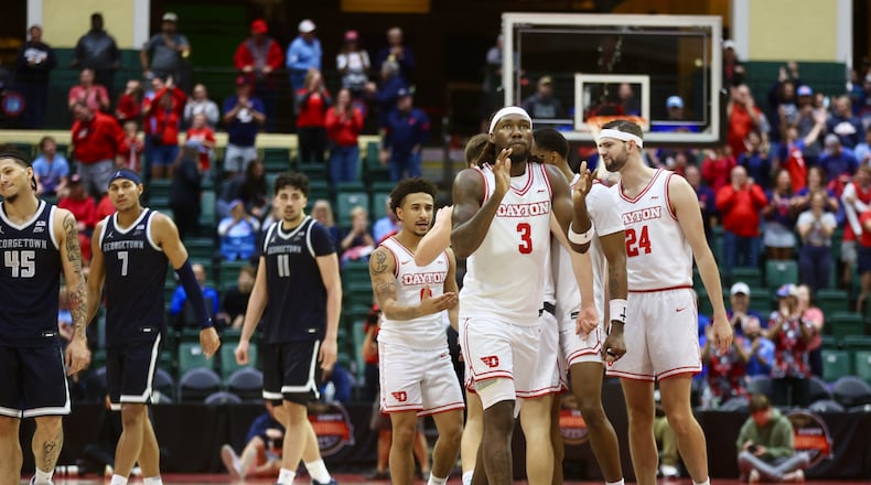 Dayton's Jaiun Simon claps as he heads to the free-throw in the final second of a victory against Georgetown on Thursday, Nov. 27, 2025, at the State Farm Field House in Kissimmee, Fla. David Jablonski/Staff
