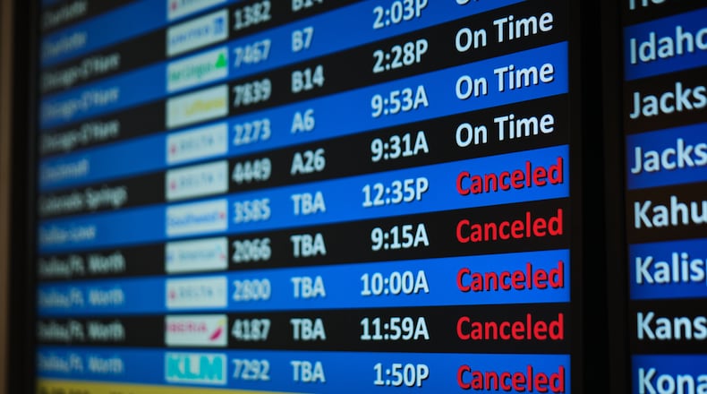 A flight status screen shows canceled flights to the Dallas-Fort Worth, Texas, area from the Salt Lake City International Airport amid a winter storm Saturday, Jan. 24, 2026, in Salt Lake City. (AP Photo/Sydney Schaefer)