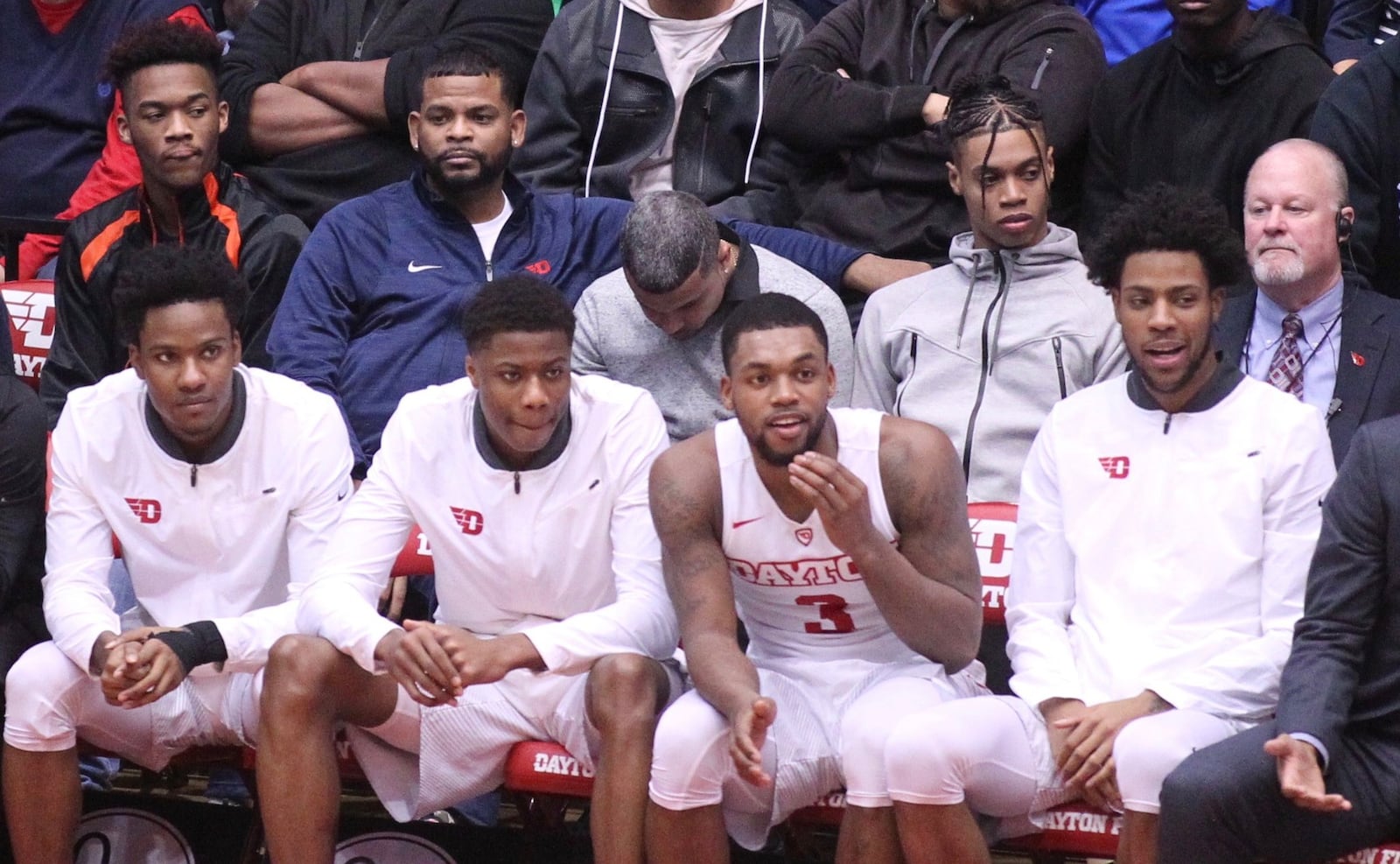 Jhery Matos, second from right in second row, watches a game against Fordham from behind the Dayton bench on Saturday, Feb. 17, 2018, at UD Arena. David Jablonski/Staff