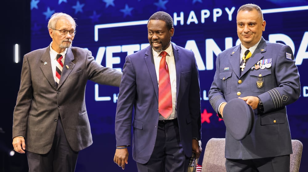 From left to right, Beavercreek Mayor Don Adams, Beavercreek Seventh-day Adventist Church pastor Delthony Gordon and Col. Gerorgios Tzamalis of the Hellenic Air Force stand during a Veterans Day ceremony on Tuesday, Nov. 11 at Be Hope Church in Beavercreek. Tzamalis was a featured speaker and one of several members of international militaries to attend. BRYANT BILLING/STAFF