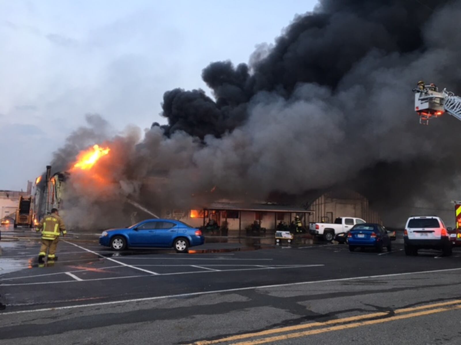 Smoke billows from an auto repair business on Spence Road in Pike Twp. Sunday morning. Joey Bryant/Staff