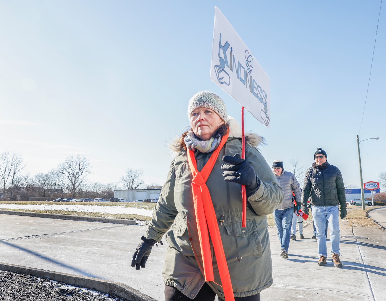 A marcher holds a "KINDNESS" sign during the Peace Walk for the National Day of Action hosted by Indivisible Springfield on Tuesday, Jan. 20, 2026, in Springfield. JOSEPH COOKE/STAFF