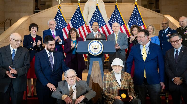 From front left: John Christman; Seymour Nussenbaum, seated; and Bernie Bluestein are honored for their service in the WWII-era "Ghost Army" during a Congressional Gold Medal ceremony on Capitol Hill in Washington, March 21, 2024. The mission of soldiers serving in units that became known as the “Ghost Army” was to deceive enemy forces as to the location and size of American troop movements. (Maansi Srivastava/The New York Times)
