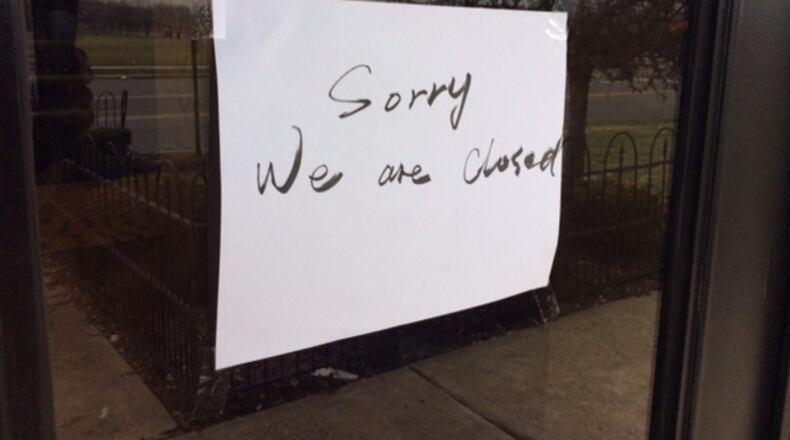 A hand-lettered sign reading “Sorry We are Closed” is taped to the front door of the Osaka Sushi & Hibachi Buffet restaurant at 8901 Kingsridge Drive behind the Dayton Mall. MARK FISHER/STAFF
