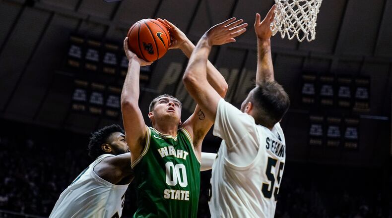 Wright State forward Grant Basile (00) shoots over Purdue guard Sasha Stefanovic (55) during the first half of an NCAA college basketball game in West Lafayette, Ind., Tuesday, Nov. 16, 2021. (AP Photo/Michael Conroy)