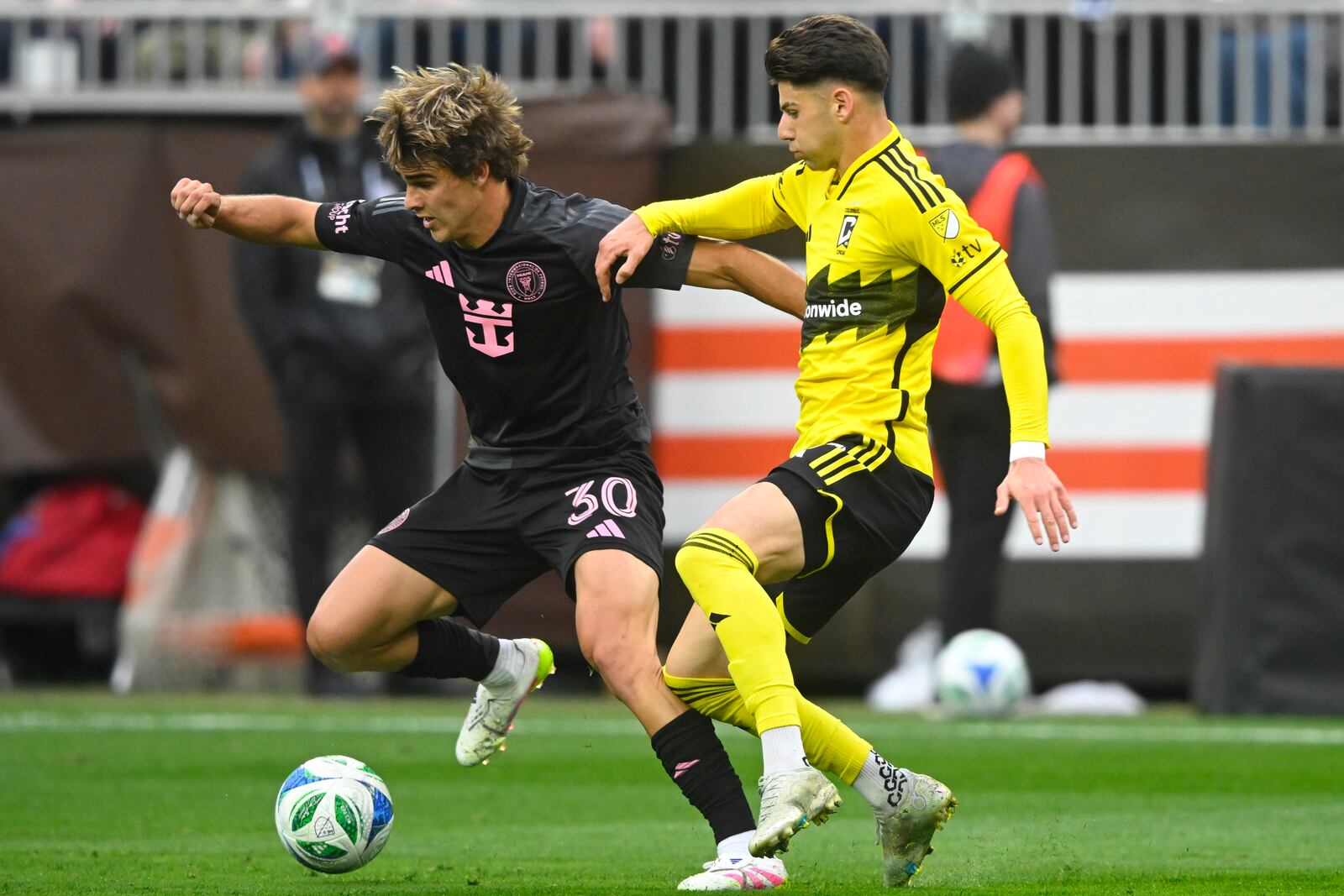 Inter Miami midfielder Benjamin Cremaschi (30) controls the ball beside Columbus Crew forward Max Arftsen, right, during the first half of an MLS soccer match Saturday, April 19, 2025, in Cleveland, Ohio. (AP Photo/David Richard)
