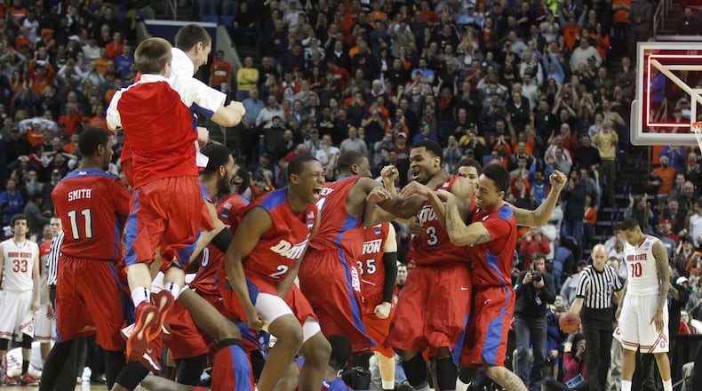 Dayton players celebrate after a 60-59 victory against Ohio State in the second round of the NCAA tournament on Thursday, March 20, 2014, at the First Niagara Center in Buffalo, N.Y. David Jablonski/Staff