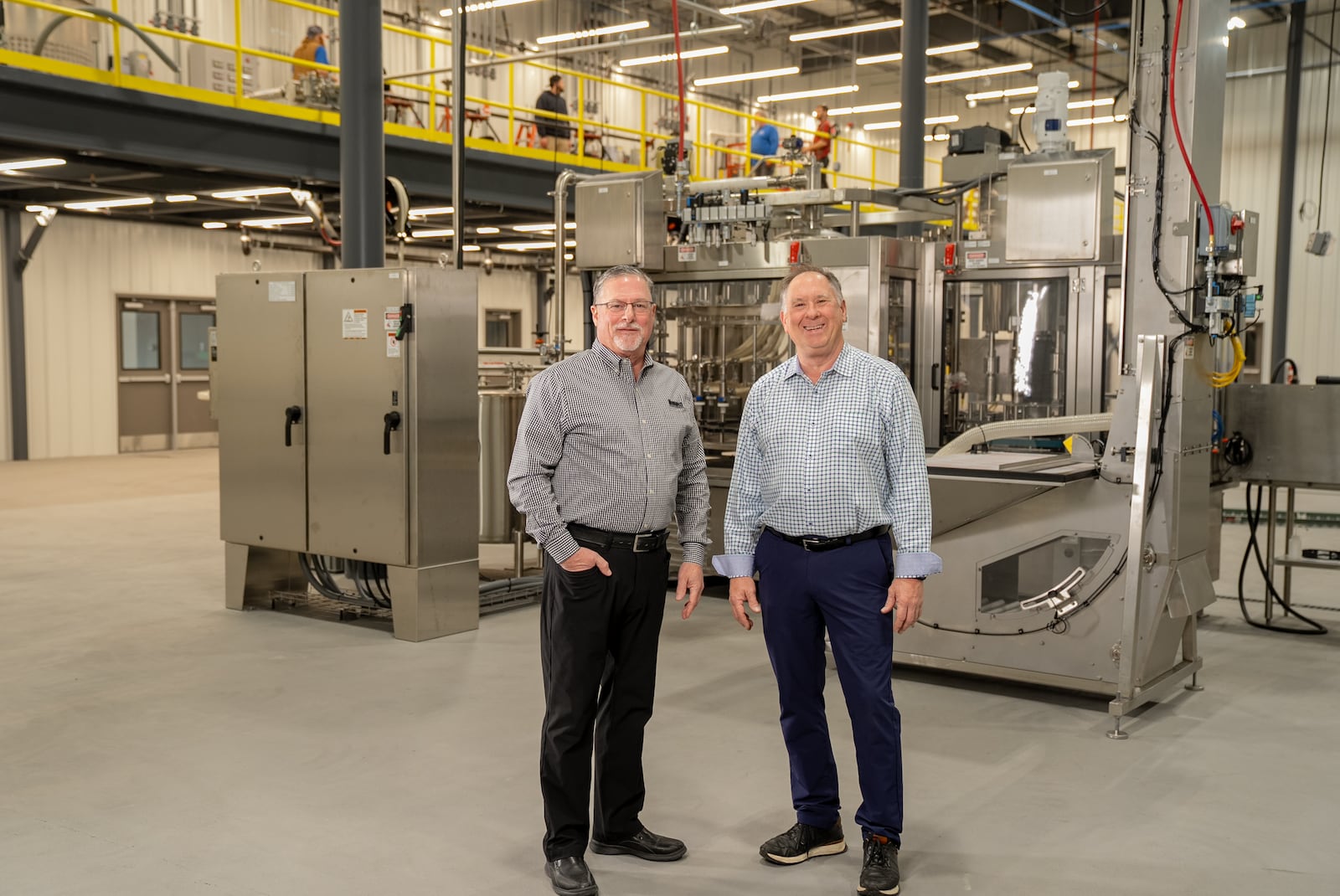 Brian Ault, executive vice president of sales and development at Bruns General Contracting, and David Sipos, president of Belton Foods, at Belton Foods' new $8 million,  73,750-square-foot facility recently completed by Bruns General Contracting at the Englewood Otterbein Industrial Park. CONTRIBUTED