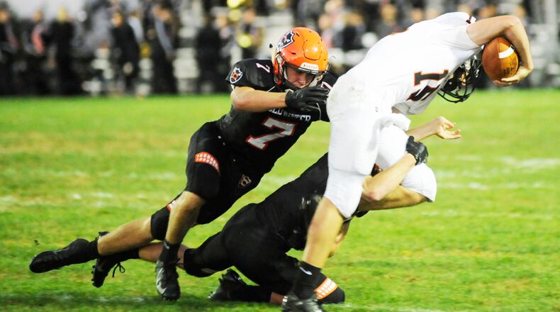 Coldwater’s Myles Blasingame (7) takes down Minster QB Jacob Niemeyer. Coldwater defeated visiting Minster 31-20 in a Week 4 high school football game on Friday, Sept. 14, 2018. MARC PENDLETON / STAFF