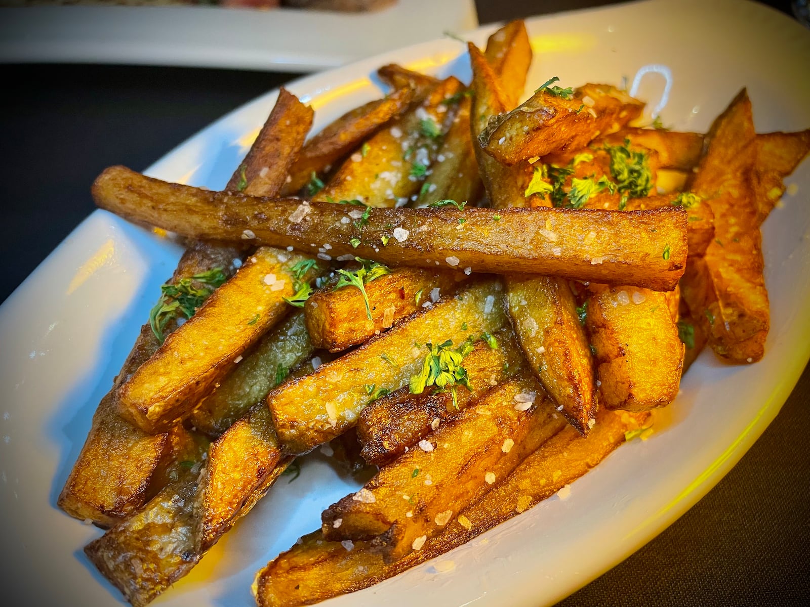 Mar’Tae Kitchen & Cocktails is located at 5212 Salem Ave. in Trotwood. Pictured is the garlic parmesan truffle fries from the soft opening. NATALIE JONES/STAFF