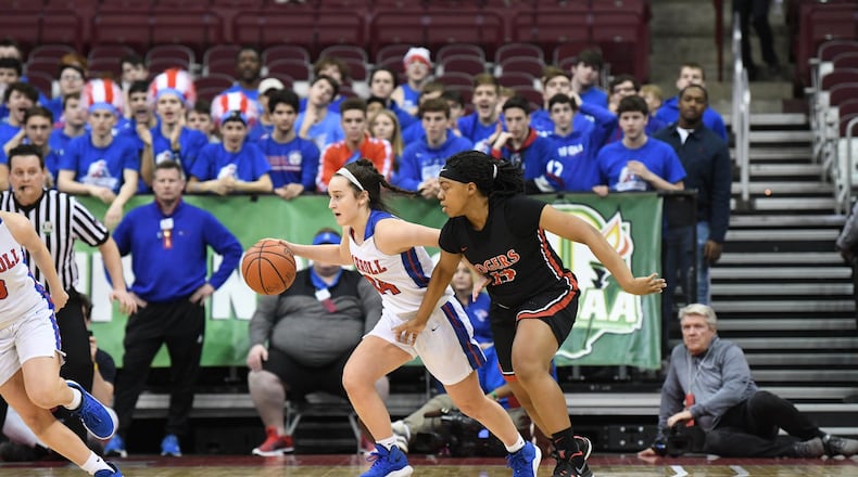 Carroll’s Allie Stefanek (left) tries to drive past Diamond Ezell of Toledo Rogers player during Saturday’s Division II championship game at the Schottenstein Center in Columbus. Nick Falzerano/CONTRIBUTED