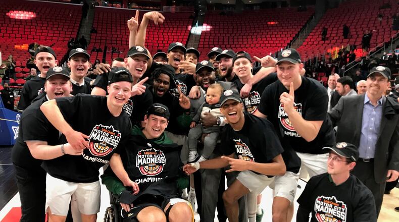 Wright State, including assistant coach Sharif Chambliss and son Julian (center), celebrate the Raiders’ win over Cleveland State in the Horizon League Championship game in 2018. CONTRIBUTED