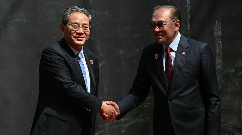 China's Premier Li Qiang, left, shakes hands with Malaysia's Prime Minister Anwar Ibrahim as he arrives at the Kuala Lumpur Convention Centre to attend the 47th Association of Southeast Asian Nations (ASEAN) summit in Kuala Lumpur, Malaysia, Monday, Oct. 27, 2025. (Lillian Suwanrumpha/Pool Photo via AP)