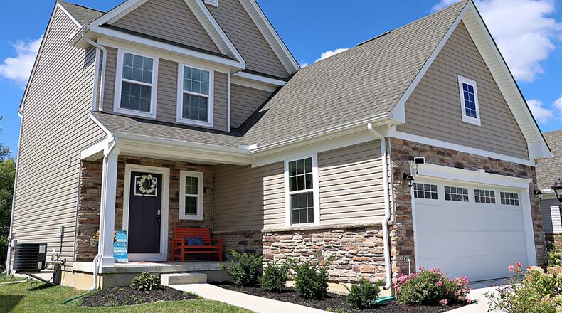 The vinyl-and-stone home has about 1,885 sq. ft. of living space plus the finished basement. The property has an open, tree-lined back yard, a balcony wooden deck and an attached, 2-car garage. CONTRIBUTED PHOTO BY KATHY TYLER