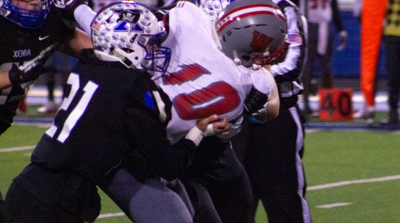 Xenia defensive back Mickey Penewit tackles Columbus Walnut Ridge’s Antonio Tucker during the first half of Friday night’s Division II playoff game at Xenia. Jeff Gilbert/CONTRIBUTED