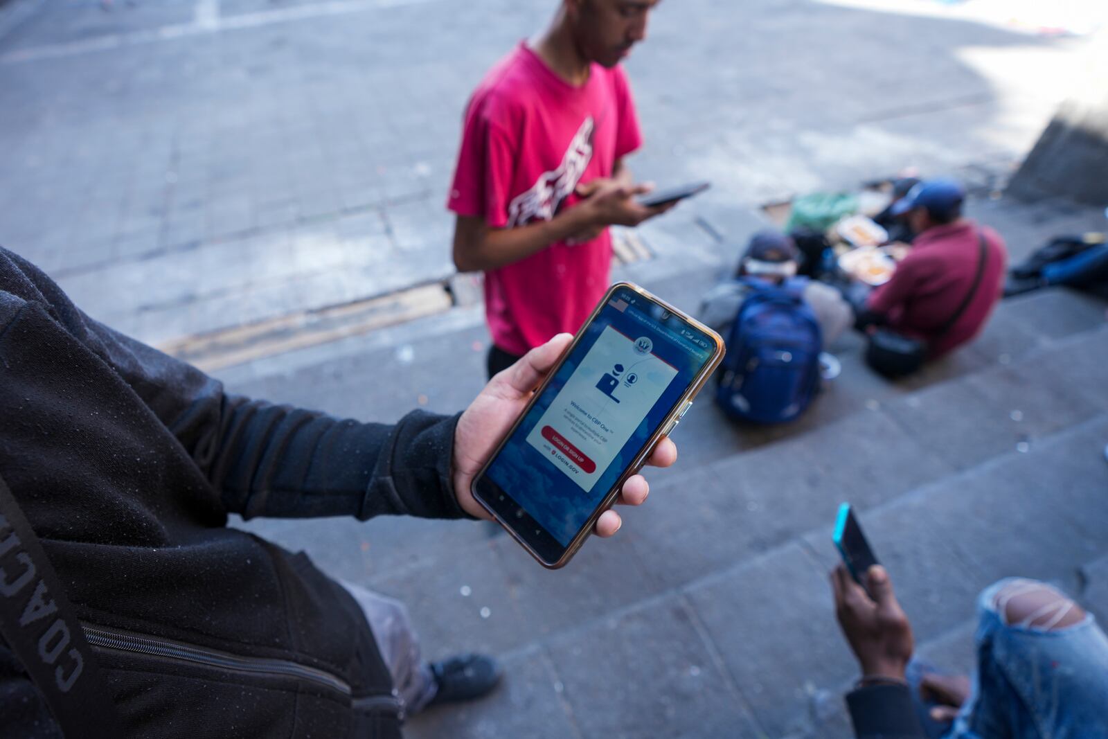 FILE - Venezuelan migrant Yender Romero shows the U.S. Customs and Border Protection (CBP) One app on his cell phone, which he said he used to apply for asylum in the U.S. and is waiting on an answer, at a migrant tent camp outside La Soledad church in Mexico City, Jan. 20, 2025. (AP Photo/Fernando Llano, File)