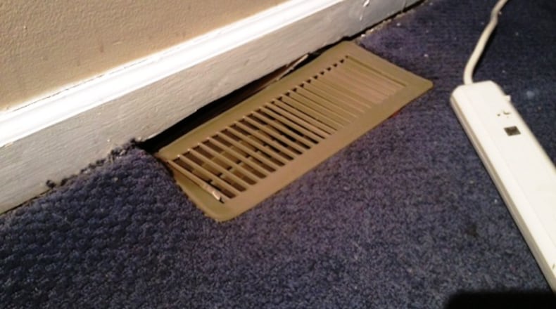 University of Dayton students called the fire department when they discovered that the first floor of their university-owned house was sinking. A UD building maintenance official allowed the students to remain in the house. (KATE BARTLEY/STAFF)