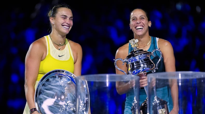 FILE -Madison Keys, right, of the U.S. reacts as she holds the Daphne Akhurst Memorial Cup after defeating Aryna Sabalenka, left, of Belarus in the women's singles final at the Australian Open tennis championship in Melbourne, Australia, Jan. 25, 2025. (AP Photo/Asanka Brendon Ratnayake, File)