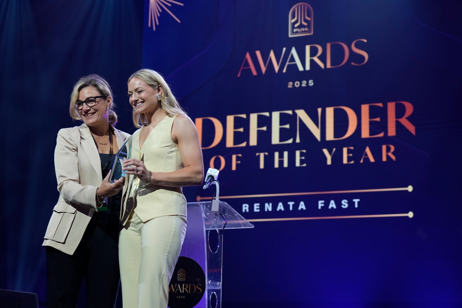Cheryl Pounder, left, presents Toronto Sceptres' Renata Fast with the Defender of the Yearduring the PWHL women's hockey awards in Ottawa, Ontario,, Wednesday June 25, 2025. (Adrian Wyld/The Canadian Press via AP)