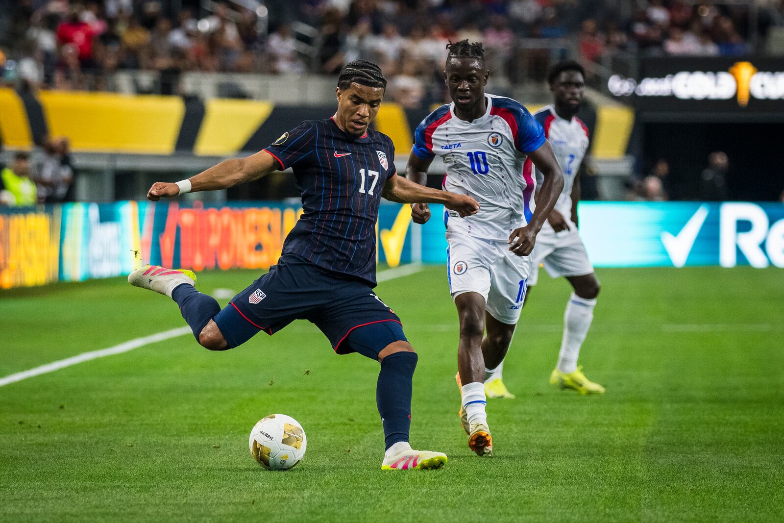 United States forward Malik Tillman (17) crosses the ball during a CONCACAF Gold Cup soccer match against Haiti, Sunday, June 22, 2025, in Arlington, Texas. (AP Photo/Jessica Tobias)