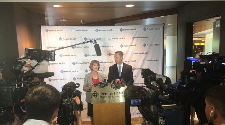 Mary Boosalis, CEO of Premier Health, left, and Mike Uhl, president of Miami Valley Hospital, speak to reporters following President Donald Trump’s visit. KAITLIN SCHROEDER