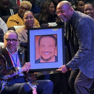 This photo provided by Capital Entertainment, Grammy Award Nominated Gospel Singer Richard Smallwood is handed a portrait of himself during his 75th Birthday Celebration. (Capital Entertainment via AP)