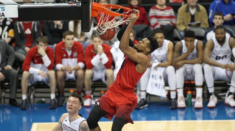 Charles Cooke dunks in the first half. David Jablonski/Staff