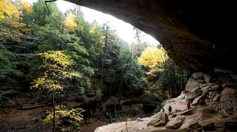 Hikers enjoy the fall foliage and explore Old Man’s Cave at Hocking Hills State Park last fall. (Kristen Zeis, Columbus Dispatch)