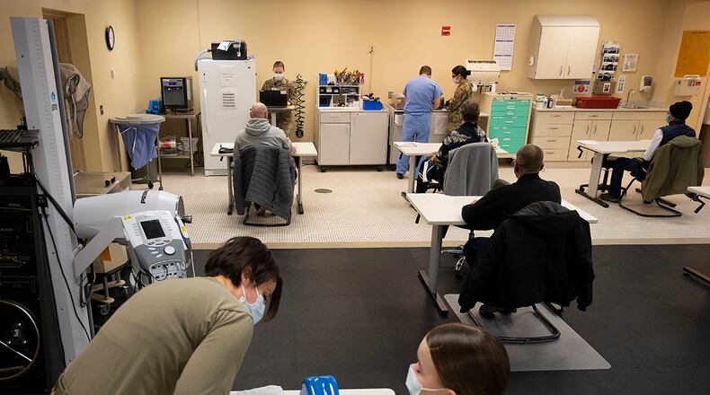 Capt. Emily Philips, 88th Operational Medical Readiness Squadron occupational therapist, demonstrates splinting a hand Jan. 25 on Airman 1st Class Leah Fitzke in Wright-Patterson Medical Center. U.S. AIR FORCE PHOTO/R.J. ORIEZ