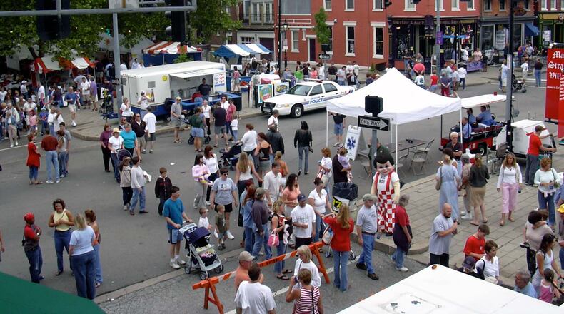 Like Hamilton’s 17 Strong “micro-grants” of up to $3,000 for a neighborhood that have been offered since last year, the Center for Great Neighborhoods for about 10 years has offered grants of up to $5,000 for community-building projects. A top goal of Covington grants, like those in Hamilton, is to help engage new people in each neighborhood. Pictured in the city’s MainStrasse area during a festival. STAFF FILE PHOTO