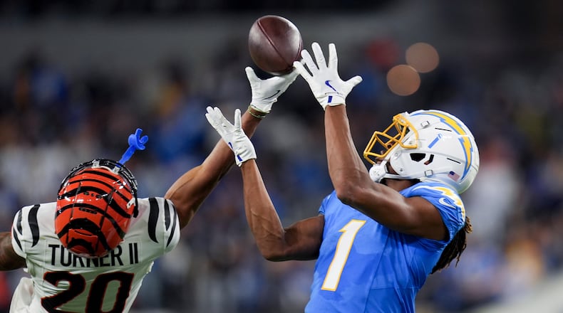 Cincinnati Bengals cornerback DJ Turner II (20) breaks up a pass intended for Los Angeles Chargers wide receiver Quentin Johnston (1) during the second half of an NFL football game Sunday, Nov. 17, 2024, in Inglewood, Calif. (AP Photo/Gregory Bull)