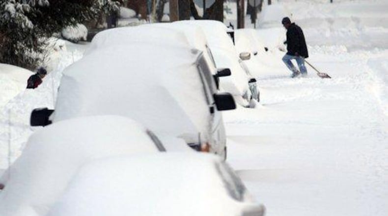 The late December storm of 2004 left automobiles buried and streets covered in snow. DAYTON DAILY NEWS ARCHIVE