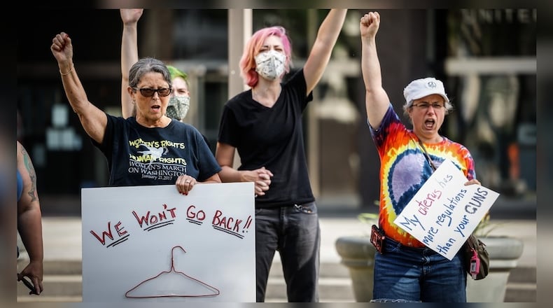 Abortion rights supporters gathered on the lawn of the Federal Courthouse in Dayton Friday after Roe V. Wade was overturned by the U.S. Supreme Court. Jim Noelker/Staff