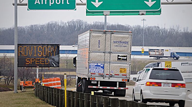 The Ohio Department of Transportation has placed extra signage at the entrance to the flyover ramp from I-75 north bound to I-70 west after the latest overturned truck closed the ramp for hours on Thursday. MARSHALL GORBY / STAFF