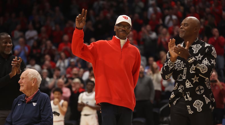 Roosevelt Chapman waves to the crowd during a ceremony honoring members of Dayton's 1984 Elite Eight team at halftime of a game against Grambling State on Saturday, Dec. 2, 2023, at UD Arena. David Jablonski/Staff