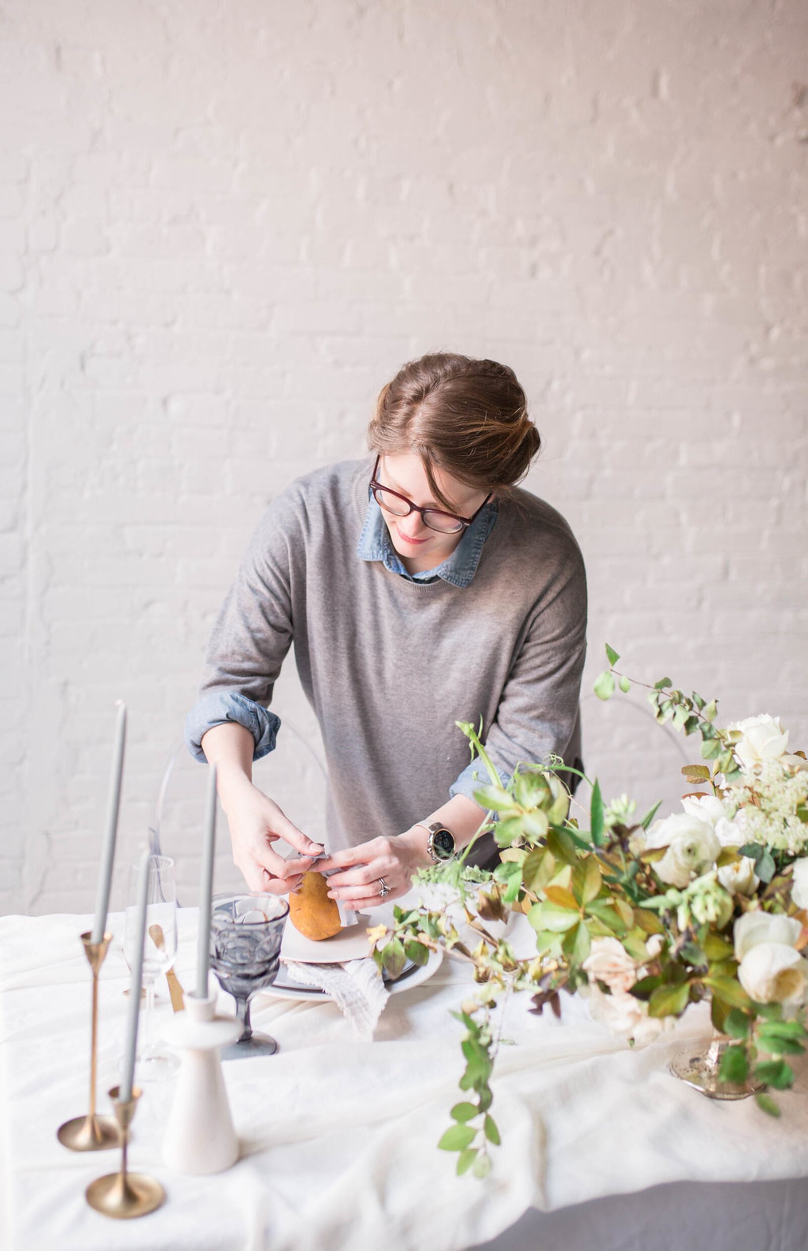 Mari on set at a photo shoot styling the table decor. Photo contributed by Mari Foster.
