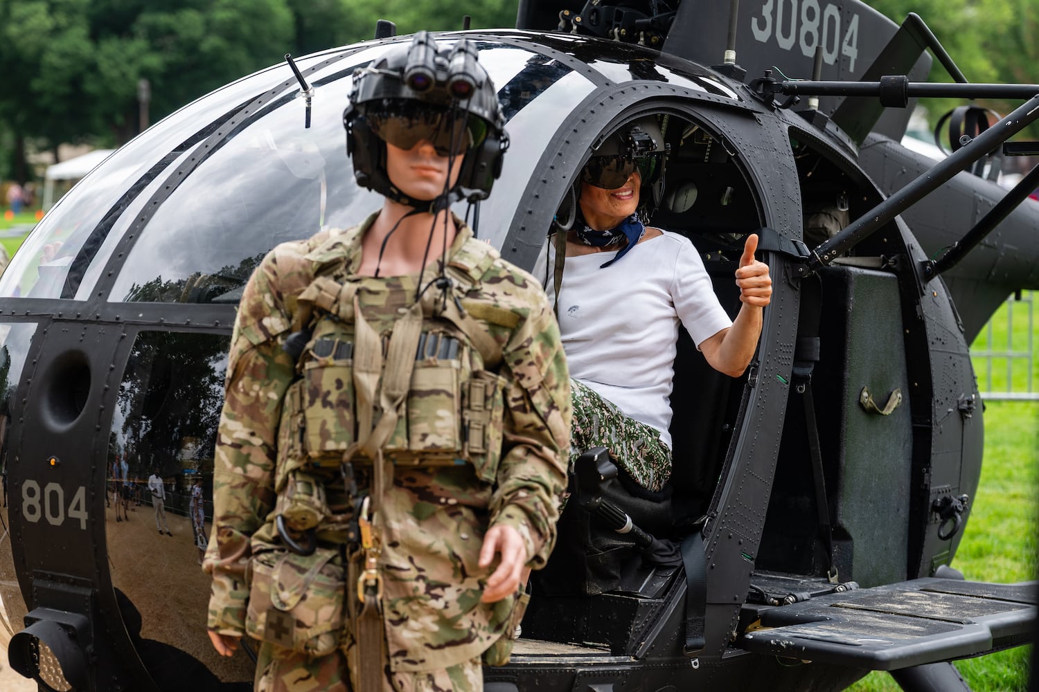 A woman poses for a photo in a helicopter during the U.S. ArmyÕs 250th anniversary festival on the National Mall in Washington, on Saturday, June 14, 2025. (Eric Lee for The New York Times)