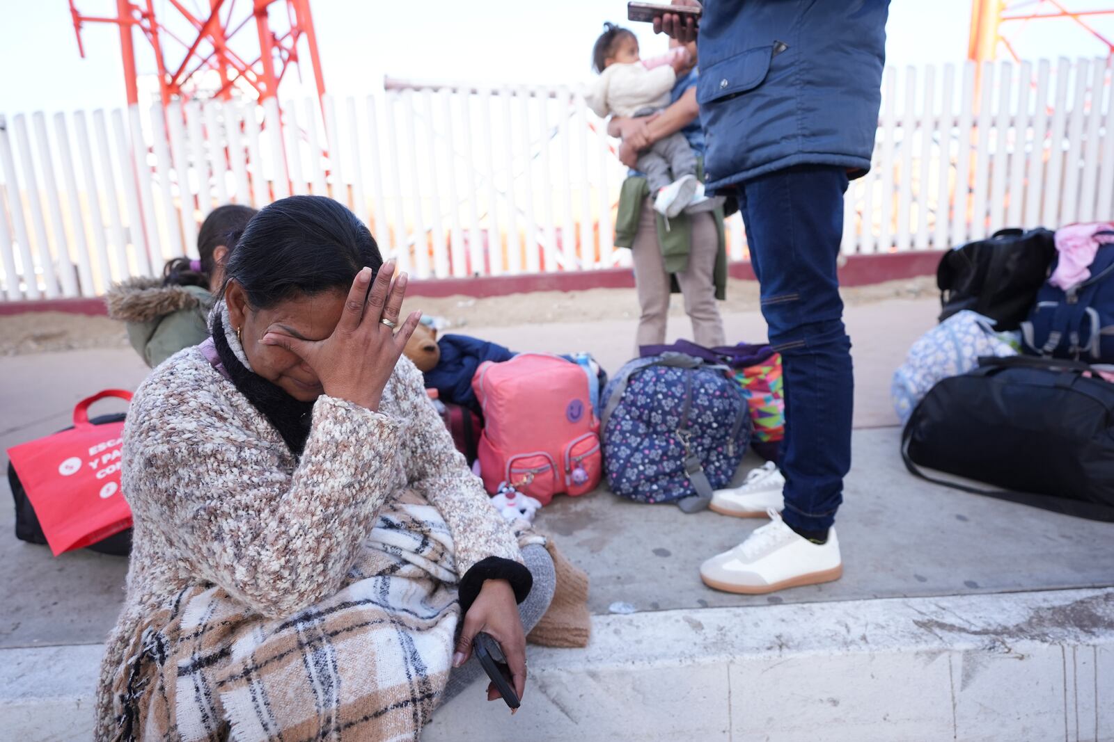 FILE - Maria Mercado, who is from Colombia but arrived from Ecuador, gets emotional as she sees that her 1 p.m. appointment was canceled on the U.S. Customs and Border Protection (CBP) One app, as she and her family wait at the border crossing in Tijuana, Mexico, Jan. 20. 2025. (AP Photo/Gregory Bull, File)