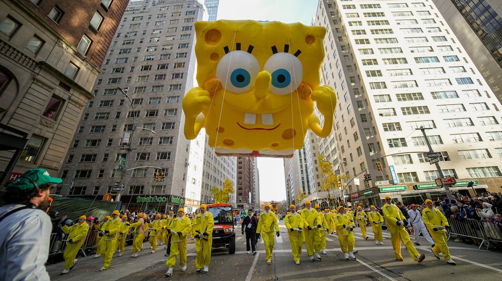 Balloon handlers guid the Sponge Bob Square Pants balloon down Sixth Avenue during the Macy's Thanksgiving Day Parade, Thursday, Nov. 27, 2025, in New York. (AP Photo/Eduardo Munoz Alvarez)