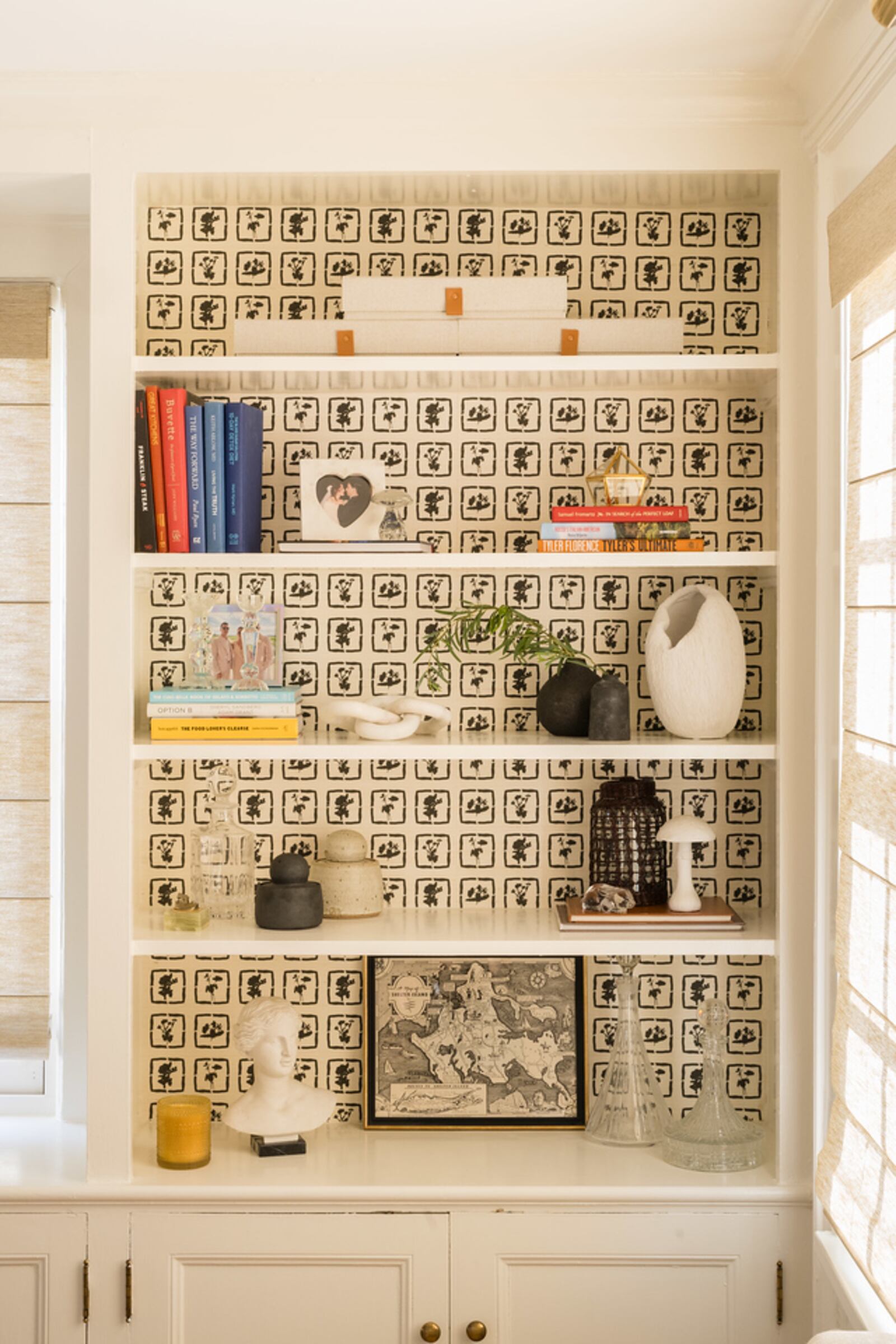 Olivia Richardson's grassscloth wallpaper featured in shelving from project in Floral Park, New York. Styling by Deanna Dewey, Photo Credit Jamie Bannon.