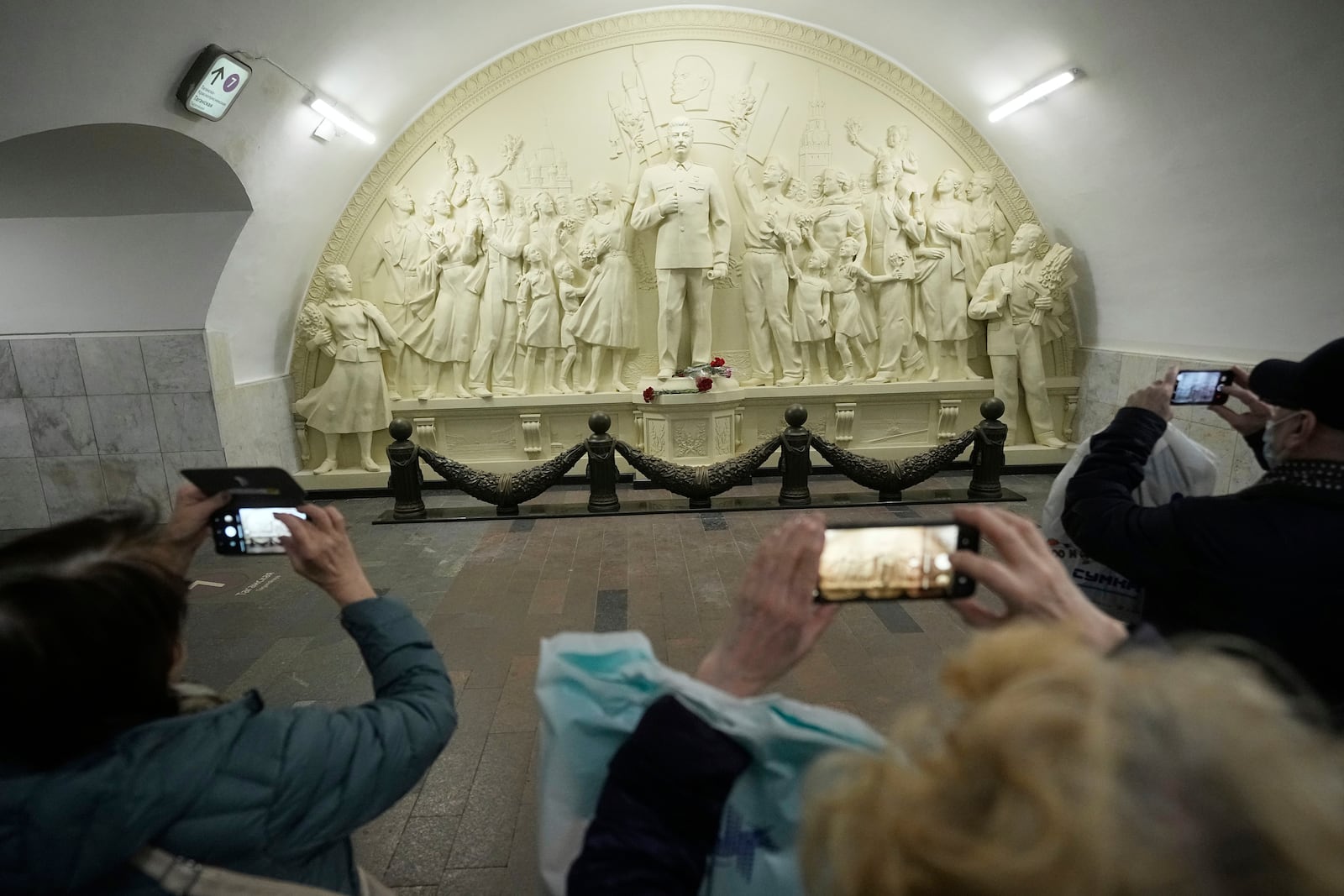 FILE - Passengers walk along a passage in front of a monument depicting Soviet leader Josef Stalin in the Taganskaya subway station in Moscow, Russia, on Wednesday, May 21, 2025. (AP Photo/Alexander Zemlianichenko, File)