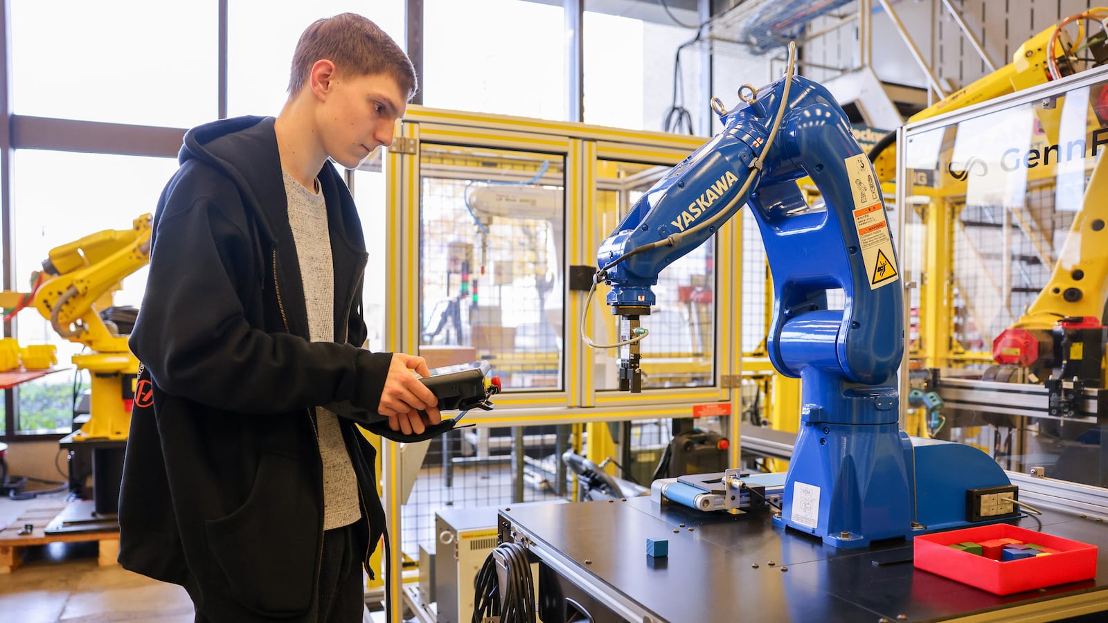 Travis Templeton works on a program with a Yaskawa training robot in a robotics lab at Sinclair Community College on Monday, Nov. 24. BRYANT BILLING/STAFF