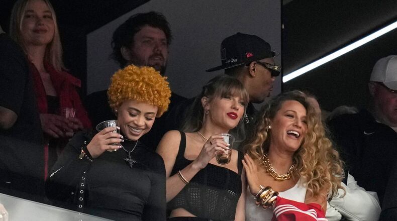 FILE - Taylor Swift, center, watches the teams before the NFL Super Bowl 58 football game between the San Francisco 49ers and the Kansas City Chiefs with Ice Spice, left, and Blake Lively, right, Feb. 11, 2024, in Las Vegas. (AP Photo/Ashley Landis, File