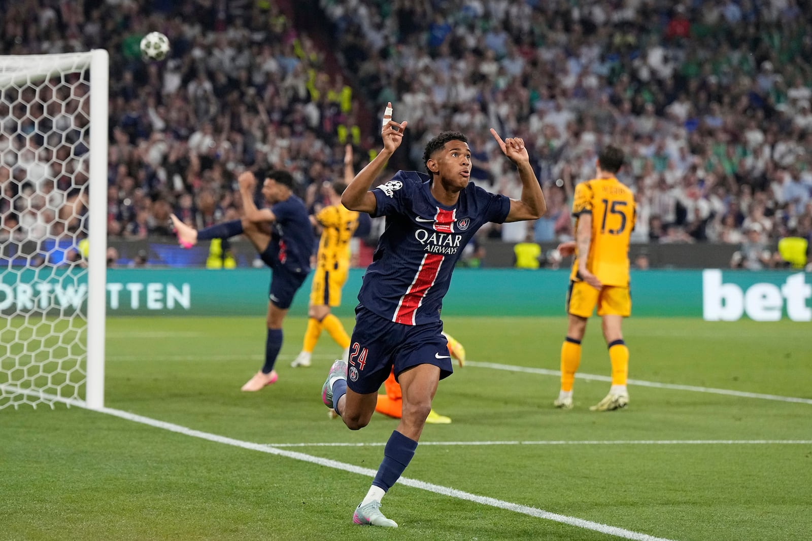 PSG's Senny Mayulu celebrates after scoring his side's fifth goal during the Champions League final soccer match between Paris Saint-Germain and Inter Milan at the Allianz Arena in Munich, Germany, Saturday, May 31, 2025. (AP Photo/Martin Meissner)