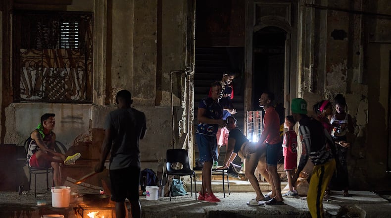 A man prepares caldosa, a traditional soup, during a birthday celebration on the street in Havana, Thursday, March 5, 2026. (AP Photo/Ramon Espinosa)