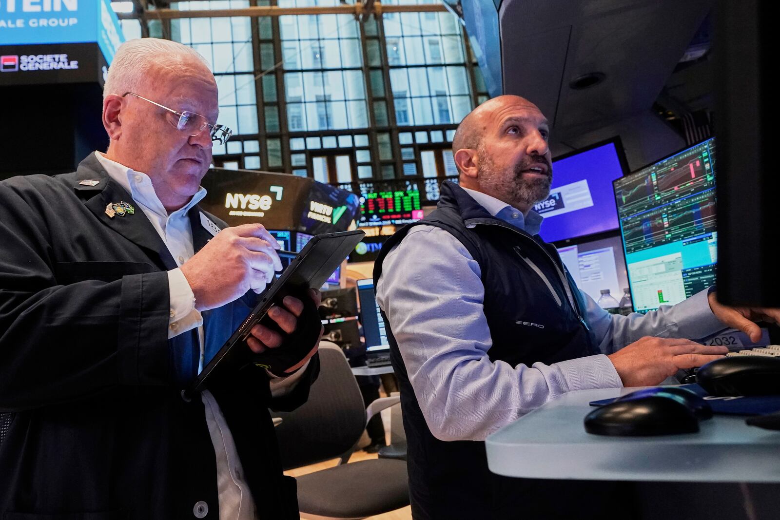 Trader Thomas Ferrigno, left, and specialist James Denaro work on the floor of the New York Stock Exchange, Tuesday, May 27, 2025. (AP Photo/Richard Drew)