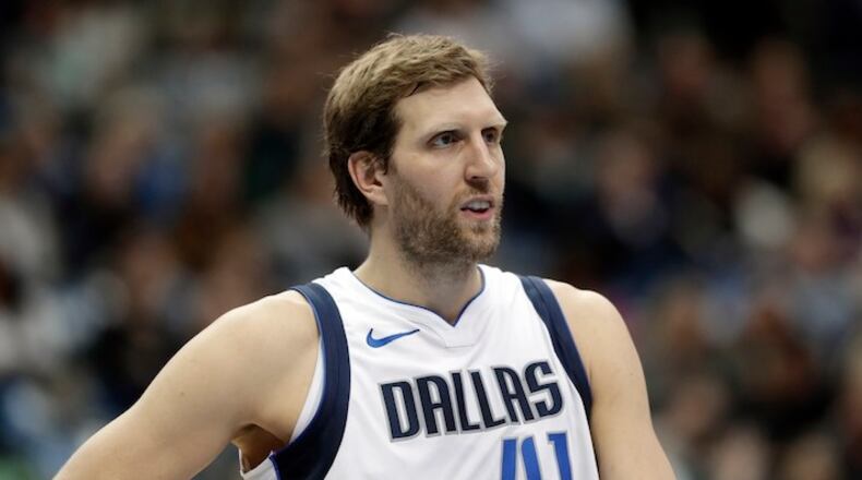 Dallas Mavericks' Dirk Nowitzki (41) of Germany watches the Orlando Magic take free throws during the first half of an NBA basketball game, Tuesday, Jan. 9, 2018, in Dallas. (AP Photo/Tony Gutierrez)
